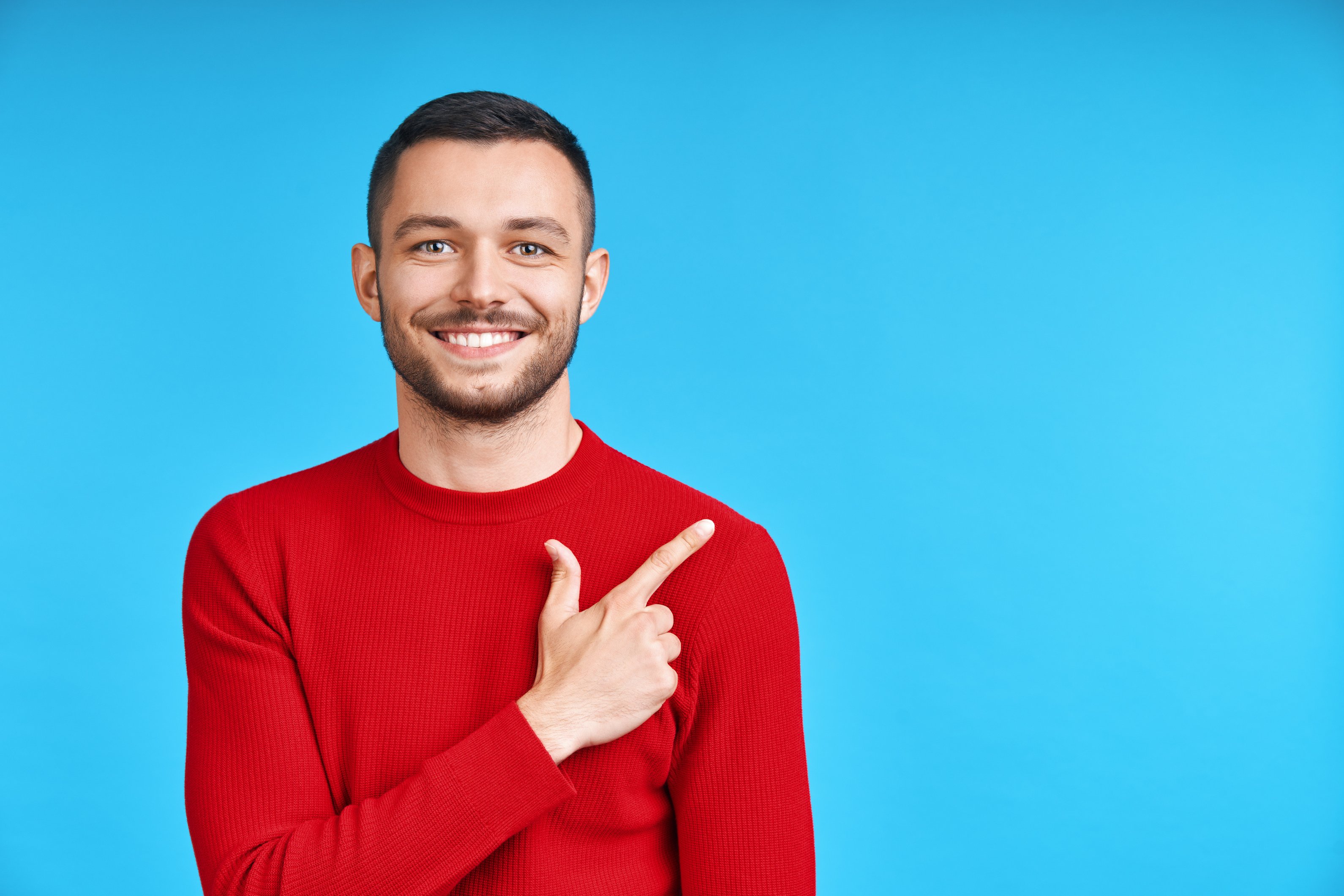 Handsome Happy Man Pointing His Finger Showing Empty Copy Space